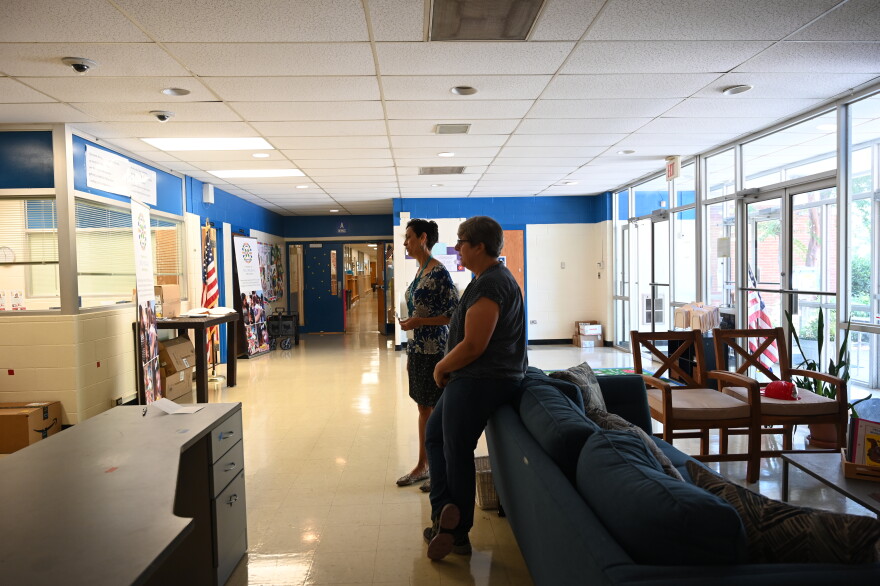 Executive Director Banu Valladares, left, and Workforce Development Director Susana Jerez speak to other educators in the lobby of Charlotte Bilingual Preschool.
