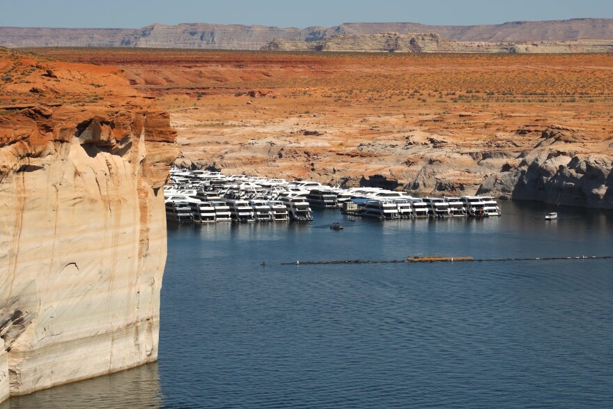 Boats sit in the low waters of Lake Powell near Page, Arizona on May 14, 2026. Climate change and drought have shrunk the Colorado River's supplies, and negotiators have struggled to rein in demand. As a result, its largest reservoirs have dropped to record low levels.