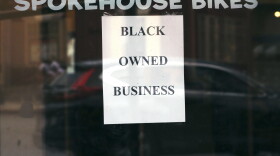 In this June 24, 2020, photograph, a sign in the window informs passersby that Spokehouse Bikes in the Upham's Corner neighborhood of Boston is a Black-owned business. (Charles Krupa/AP)