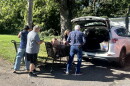 Volunteers unload groceries outside the Eastern Area Community Ministries in Louisville at the start of the city-wide food drive.