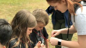 Amy Miseli, here teaching map and compass skills to Cub Scouts, plans to attend the BSA Boot Camp.