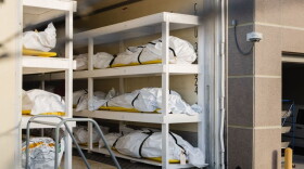 Bodies wrapped in plastic line the walls inside a refrigerated trailer used as a mobile morgue by the El Paso County Medical Examiner's office in El Paso, Texas on Nov. 13, 2020. Due to a spike in coronavirus deaths, El Paso County officials have brought in five mobile morgue trailers with five more on standby. (Justin Hamel/AFP/Getty Images) 