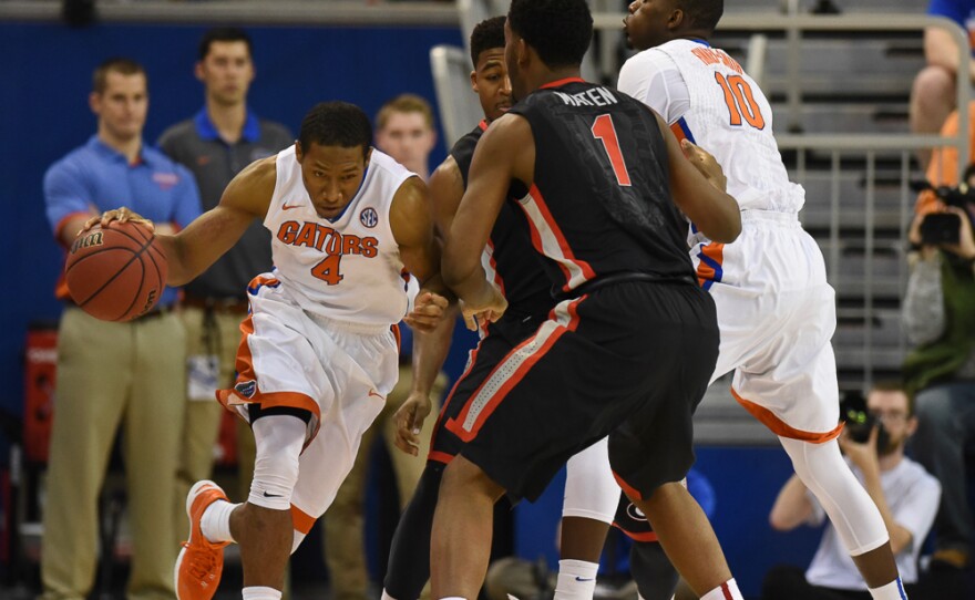 Florida's Dorian Finney-Smith (10) sets a screen for teammate KeVaughn Allen (4) allowing him to manuver past Georgia's Yante Maten (1) in the first half. (Greenberry Taylor/WUFT News)