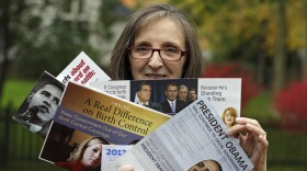 Jean Gianfagna displays some of the political mailings her family receives at her home in Westlake, Ohio, on Oct. 19. Gianfagna says her family sometimes gets four of the same piece at a time — her husband and two grown kids all get their own.