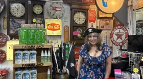 Cheryl Ring stands behind the counter at the Buccaneer Gift Shop in Fort Walton Beach, wearing a pirate hat and surrounded by vintage signs, clocks and souvenirs.