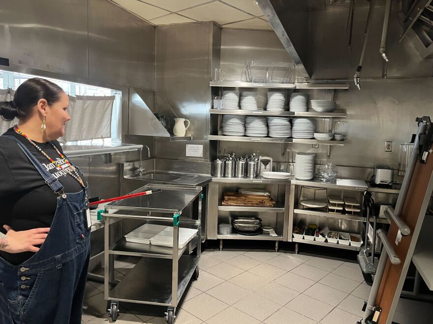 Terry stands in the upper kitchen, where hot meals will be prepared, talking through the challenges of cooking in a museum.
