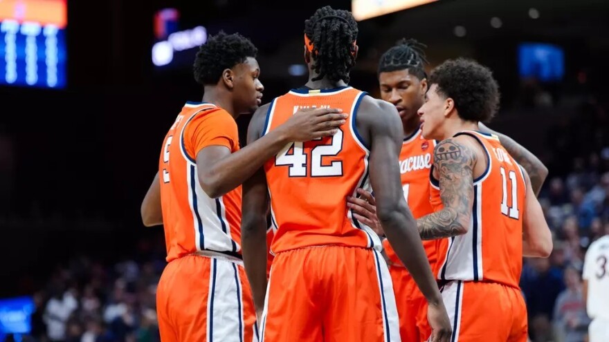 Tyler Betsey (5, Orange), William Kyle (42, Orange), Nait George (11, Orange), Donnie Freeman (1, Orange) huddled together