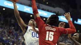 Kentucky's Otega Oweh (00) shoots while pressured by Alabama's Jarin Stevenson (15) during the first half of an NCAA college basketball game in Lexington, Ky., Saturday, Jan. 18, 2025. (AP Photo/James Crisp)