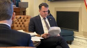 Gov. Kevin Stitt reviews budget numbers Friday during a Board of Equalization meeting at the Capitol. Stitt is chairman of the panel.