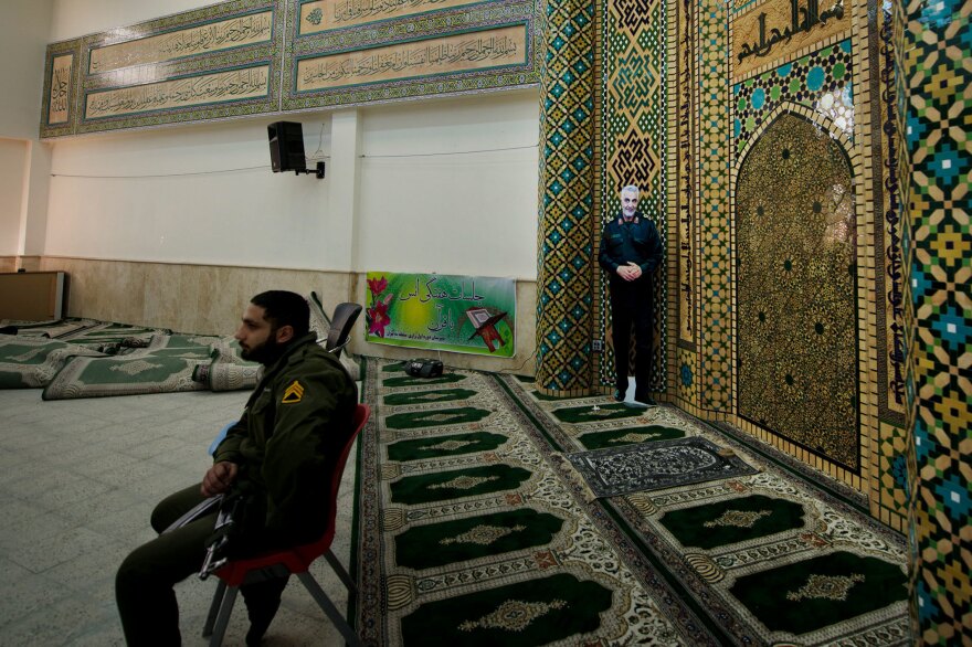 An image of Iranian Maj. Gen. Qassem Soleimani stands in the voting area in Razi school in north Tehran. The election is taking place less than two months after the U.S. carried out the targeted killing of the top military leader.