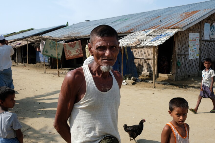 Residents of Myanmar's Thet Kae Pyin internment camp for Rohingya wait as a U.S. government delegation visits the camp.