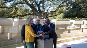 Baylor President Linda Livingstone (left), Reverend Dr. Malcolm Foley (right) and other members of Baylor's Commission on Historic Campus Representations pull a lever to officially turn on the fountain during the dedication ceremony for the Memorial to Enslaved Persons.