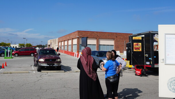 People stand by food trucks in the International Mall parking lot neighboring the Franklin County Board of Elections on Morse Road.