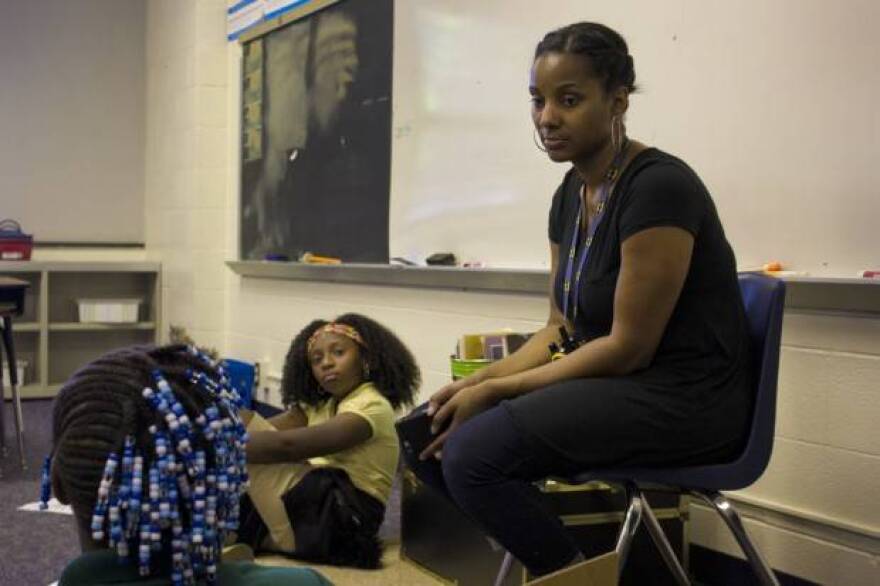 Ayana Coles, right, sits with students at Eagle Creek Elementary School. At Eagle Creek, students of color make up 77 percent of the student body, and all but four of the schoolâ€™s 37 staff are white. Coles has led conversations about race with colleagues throughout the year.