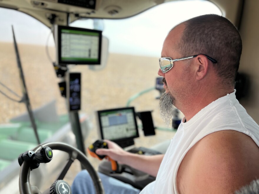 Man sitting in combine harvester