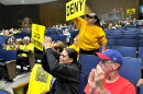 Local residents wave signs during closing arguments for the Wildcat Ridge Data Center campus' final zoning hearing.