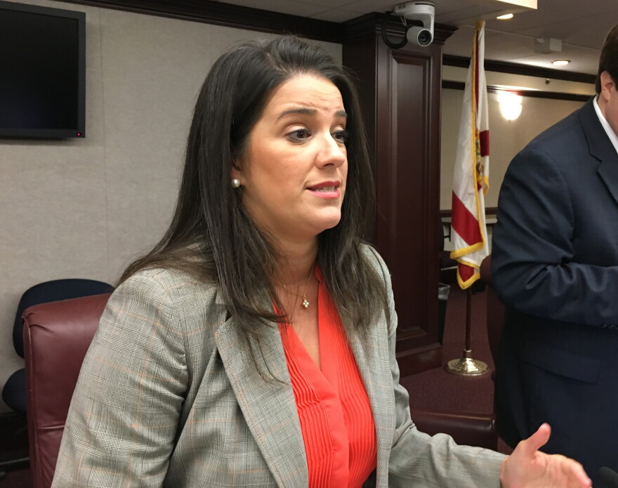 Sen. Anitere Flores speaking with reporters following a 2017 meeting of the Senate Banking Committee