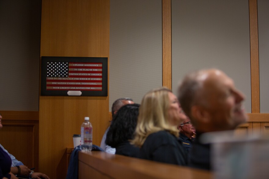 A framed American flag hangs above the courtroom at the Collin County Courthouse.