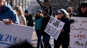 Protesters rally in front of the Ohio Statehouse in Columbus, Ohio, on Sunday, Jan. 4, 2026, after the U.S. captured Venezuelan President Nicolás Maduro and his wife in a military operation.