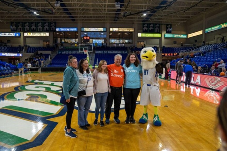 Kevin Mitchell, his family, and Zoe Horowitz pose with Azul for their first photo, which, according to them, will not be their last.