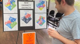 A man looks at newly drawn congressional districts for Gwinnett County, Ga., at a meeting of county Democrats earlier this month.