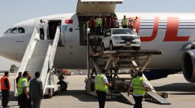 Syrian rebels say they now consider the Damascus International Airport to be part of the battle zone in their fight against Syria's government. Here, a U.N. vehicle is unloaded at the airport on May 12.