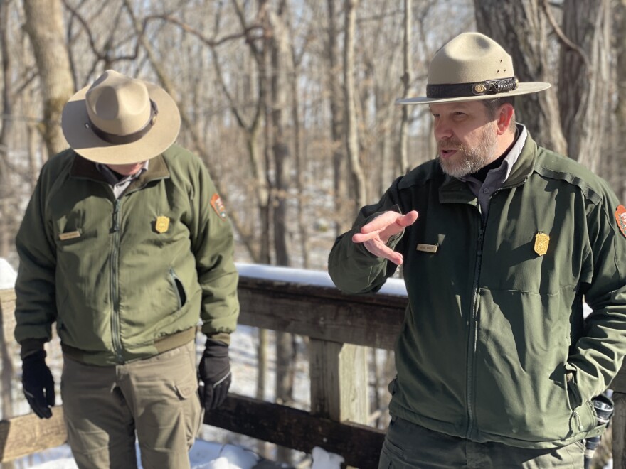 Cave Resource Specialist Rick Toomey and Park Guide Jackie Wheet recall the legend of Floyd Collins's rescue at Sand Cave's overlook.