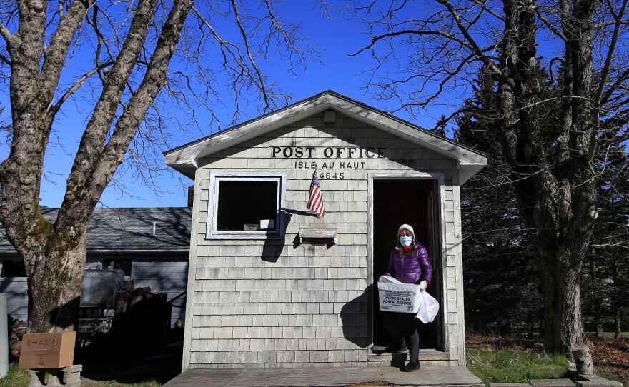 Donna DeWitt at work at the U.S. post office for Isle au Haut, Maine, where she serves about 70 customers. Advocates worry about losing the service in becoming a business.