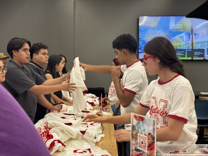 Melanie Ruiz, Student and Vice president of Student Government association welcomes students with Matador merch.