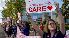 Kylie O’Keefe, an RN in the multidisciplinary clinic, holds a sign on the picket line on Monday, Sept. 25, 2023, outside SM Health St. Louis University Hospital in Midtown St. Louis. Nurses are holding a 24 hour strike, looking for a contract that addresses staffing shortages, increased pay and workplace violence prevention. Nurses gave the hospital advanced notice of the strike to allow for alternative plans to be made for patient care. 