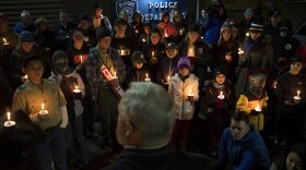 Members of the DuPont community gather to listen to mayor Mike Courts during a candlelight vigil on Wednesday, December 20, 2017, at DuPont City Hall in DuPont. 