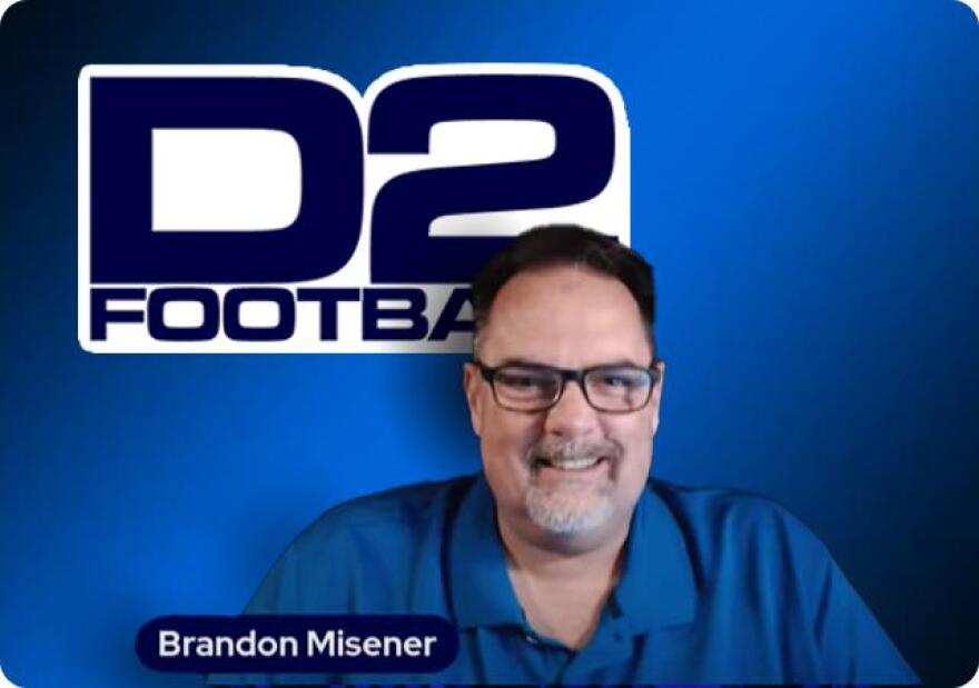 Brandon Misener with the D2 football logo behind him