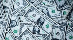 A pile of U.S. Dollar bill notes