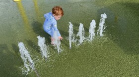 16-month-old playing at a splash park