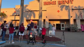 Members of the Southwest Florida Indivisible group protest outside the Home Depot in Naples, Florida, on Saturday, Dec. 20, 2025.