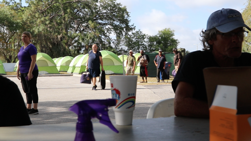 Line of homeless behind registration table