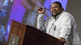 A photo of author and culinary historian Michael Twitty at a podium
