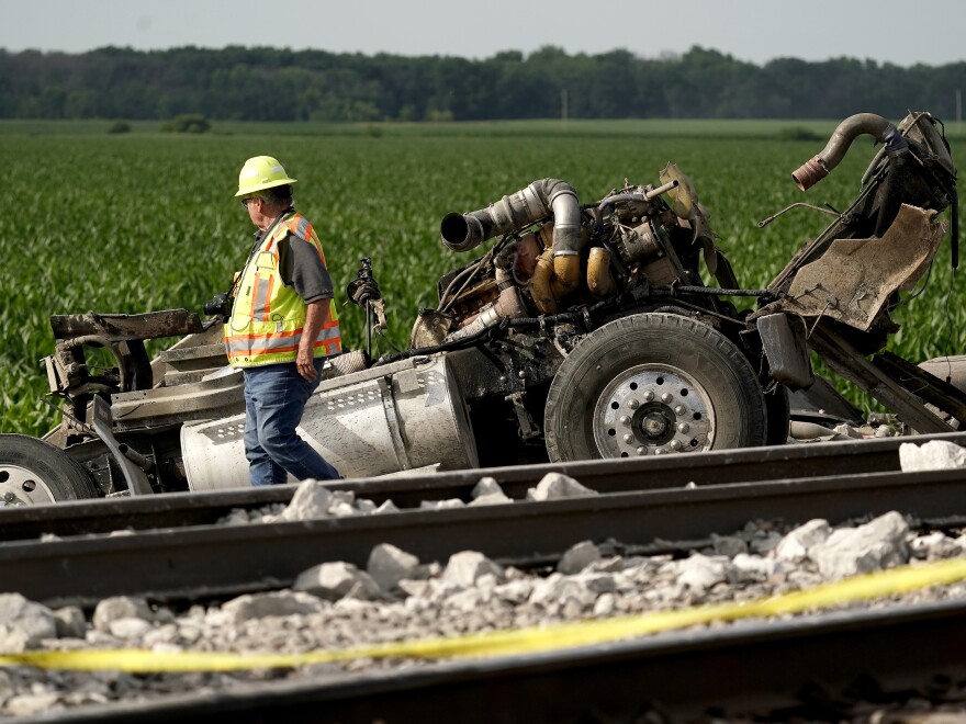 A worker looks over the dump truck that collided with the Amtrak train.