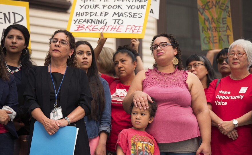 Community members gather during a rally in support of DACA recipients on Tuesday, September 5, 2017, at El Centro De La Raza in Seattle.