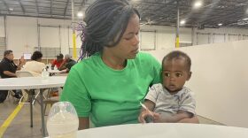 At the new family transfer center in north Houston, Haitian migrant Jouseline Metayer sits with her 7-month-old son, Jayden.