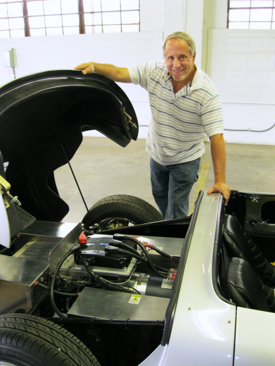 Brian Noto shows what's going on under the hood of a replica 1957 Porsche 356 Speedster in EVTV's Cape Girardeau, Mo., garage. The car runs on lithium iron phosphate batteries.
