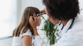 Black doctor treating white patient