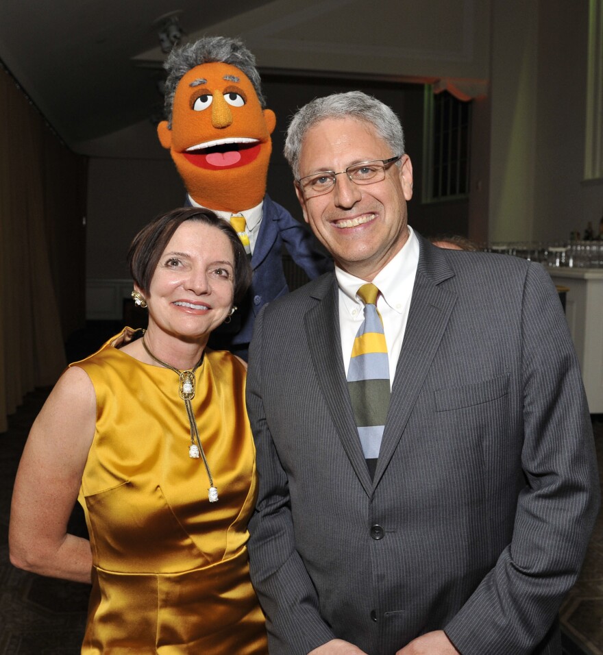 Jacki Lyden and Gary Knell pose with Gary Knell, the Muppet after the event.