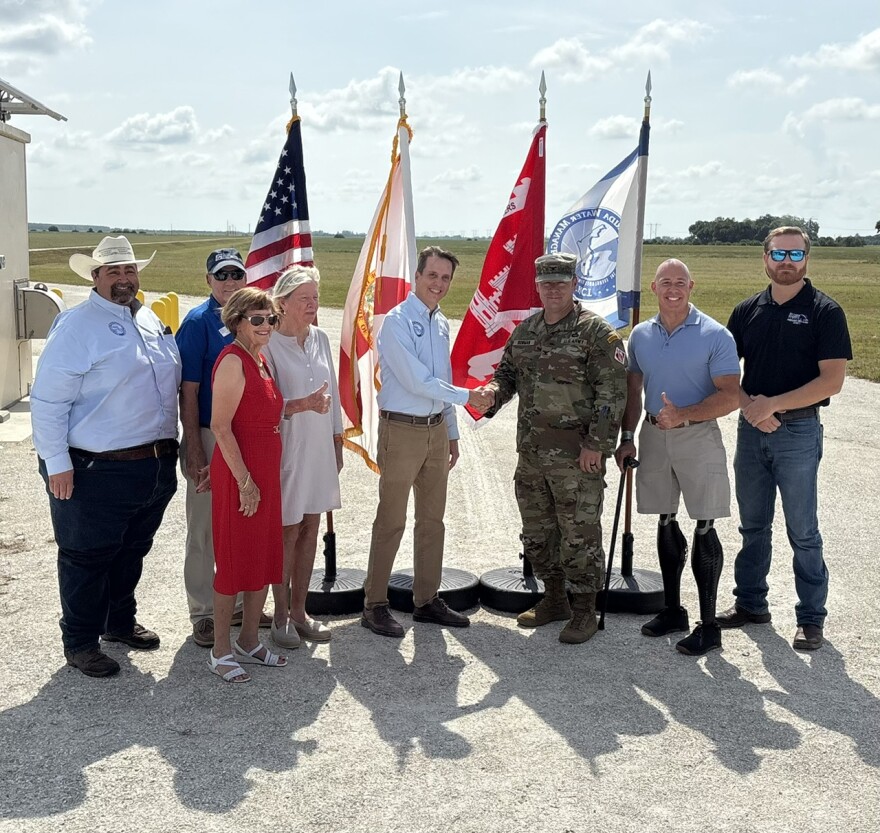 U.S. Army Corps of Engineers Jacksonville District Commander Col. Brandon Bowman and South Florida Water Management District Executive Director Drew Bartlett (center) shake hands to celebrate the milestone completions at the Indian River Lagoon South project. 