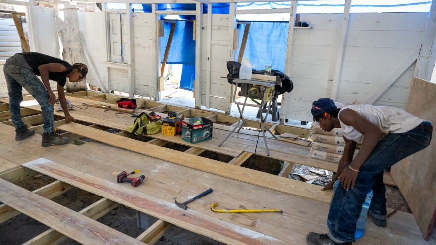 Micheal Navarro, left, and Daniel St. Jean, who are enrolled in a preservation training program offered by Crucian Heritage and Nature Tourism Inc., work on floor renovations.