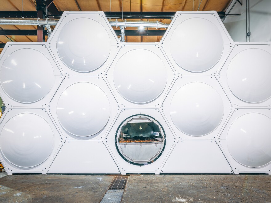 Composting vessels arranged in a honeycomb array at the Recompose human composting facility in Seattle, WA.