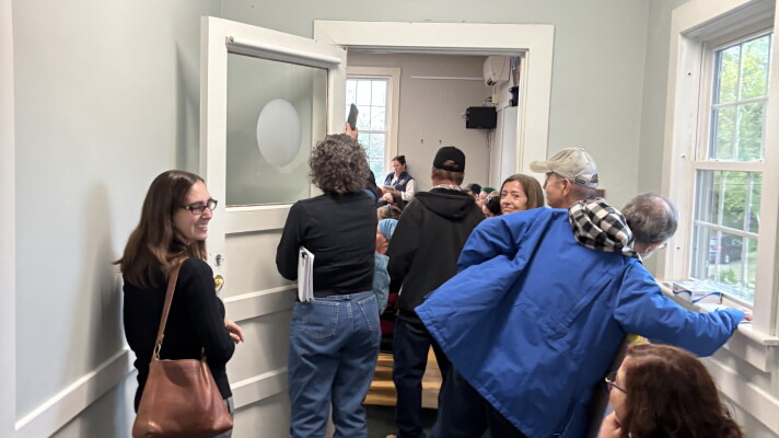 People spilled out of a select board public comment session on a potential data center in Bow, New Hampshire.