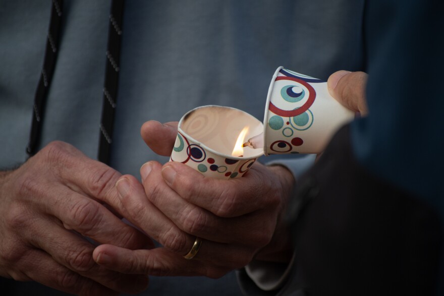 Demonstrators in Harrisonburg lit candles at a rally Sunday evening in support of local residents who live and work in the U.S. under TPS.