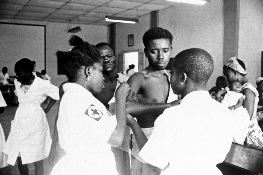 Patients in a clinic line up to get a smallpox shot on Feb. 24, 1962, in Leopoldville, Congo. Health workers used vaccination campaigns to finally eradicate smallpox by 1980.