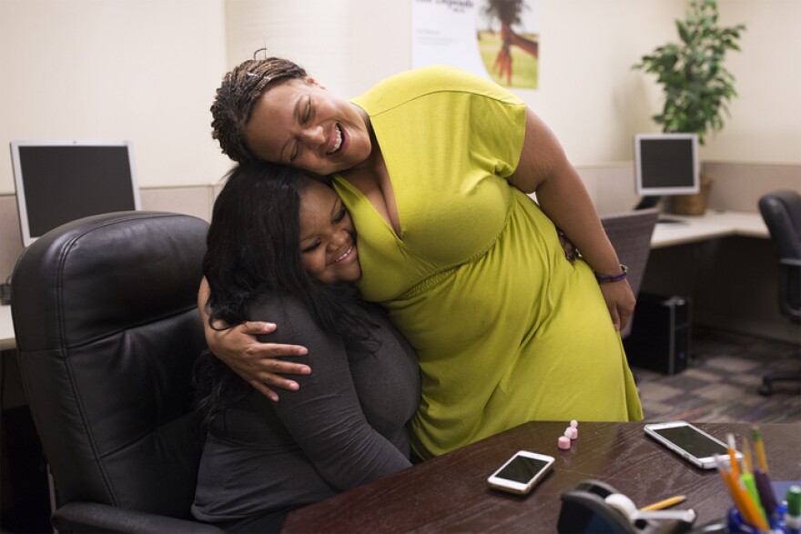 Alice Prince embraces Gladius Green at the downtown office of the St. Louis Agency on Training and Employment. Prince was recently appointed to lead SLATE, which runs job training and education programs throughout St. Louis.